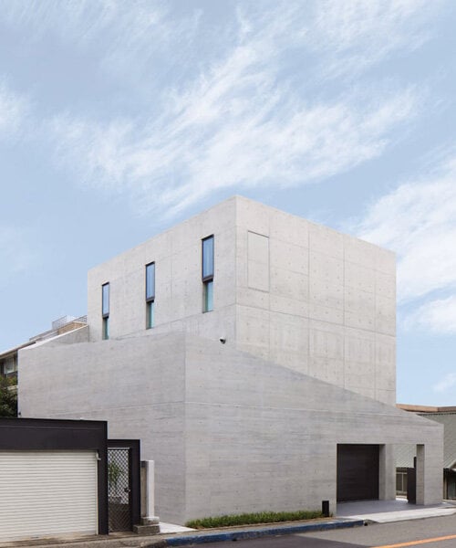 dynamic curtain of concrete walls of varying heights engulfs japanese home in tranquility