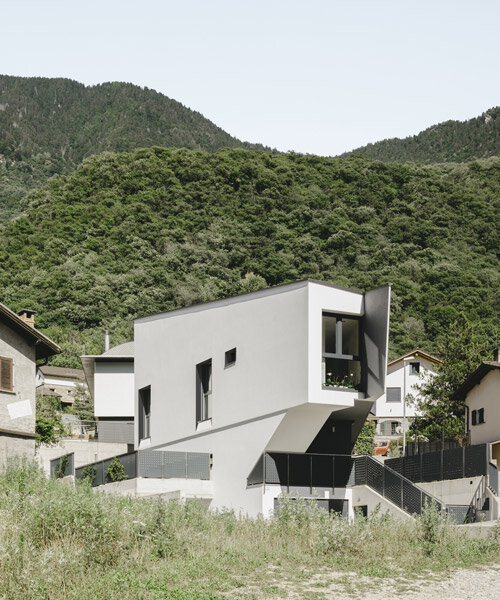 LOKOMOTIV.archs perches a tiny triangular house along a swiss hillside